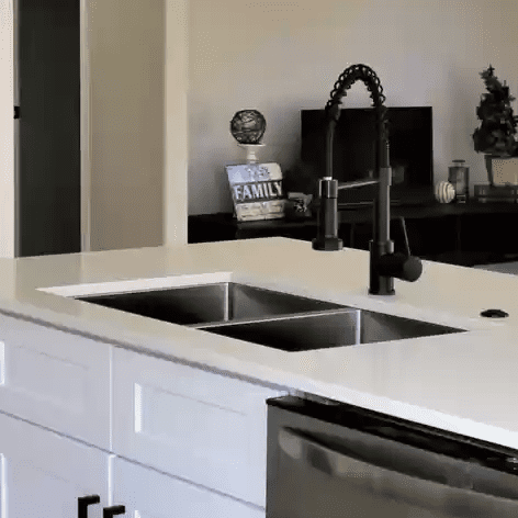 A kitchen with two sinks and a dishwasher.