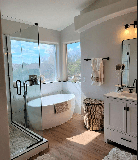 A bathroom with a tub, sink and shower.