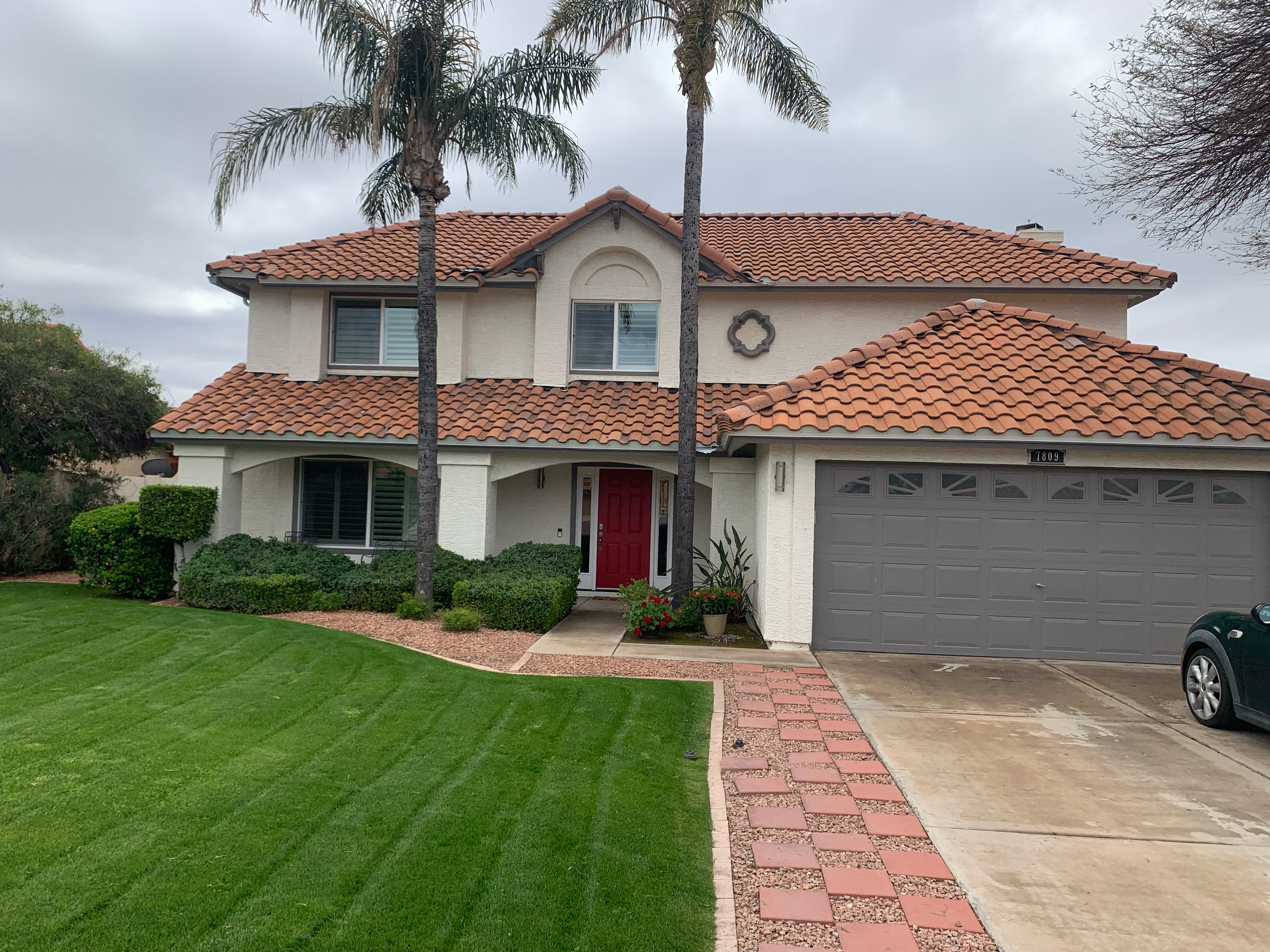 A house with red tile roof and white trim.