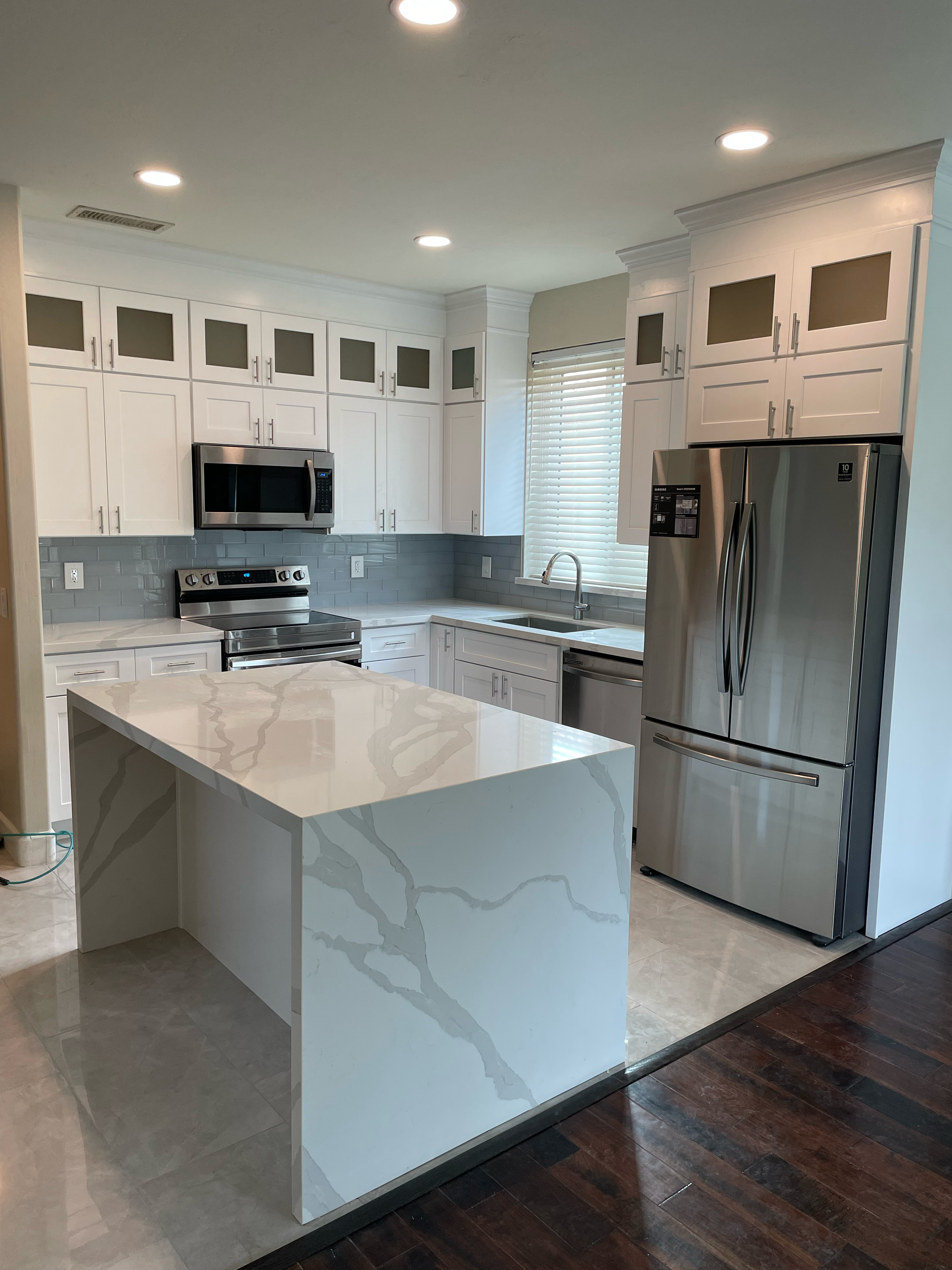 A kitchen with white cabinets and stainless steel appliances.